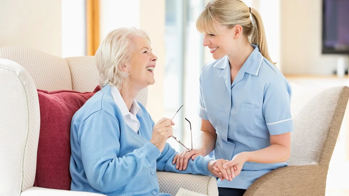 Caregiver providing attentive hands-on assistance to a senior citizen