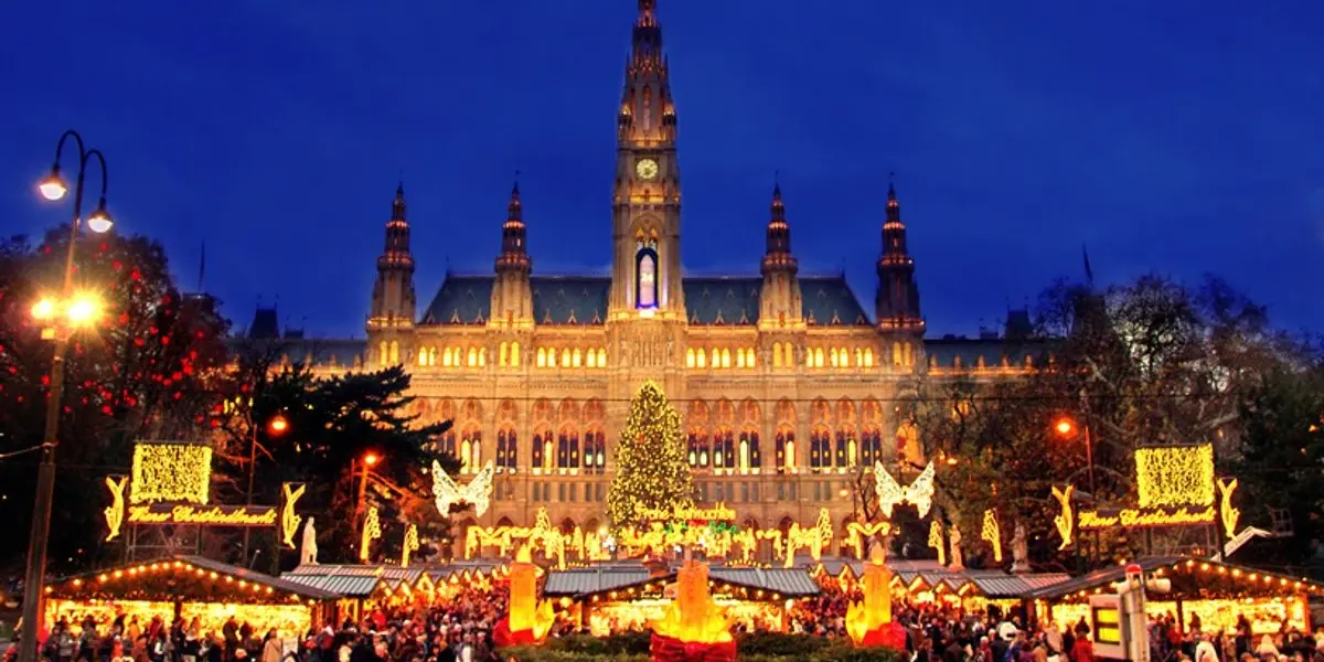 Vibrant Christmas market in front of Vienna City Hall adorned with festive lights