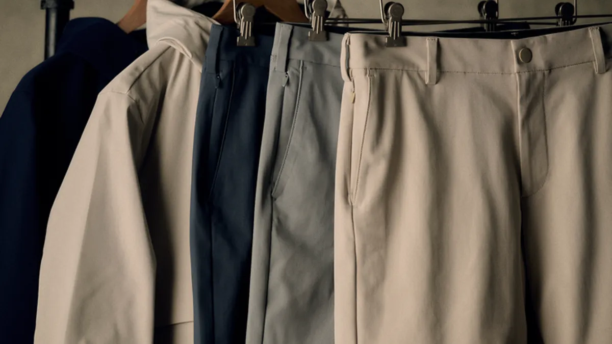 Selection of neutral tone garments hanging on a rack