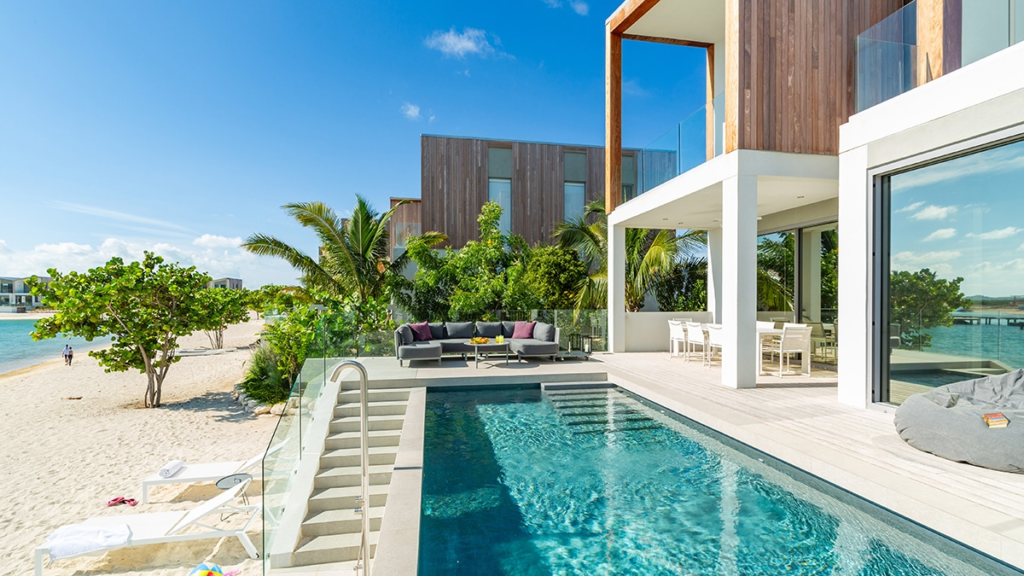Overwater bungalows with private pools surrounded by turquoise ocean waters in the Maldives.