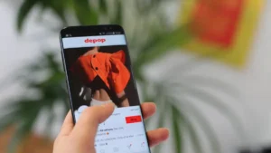 Depop-style secondhand fashion marketplace listings on a smartphone