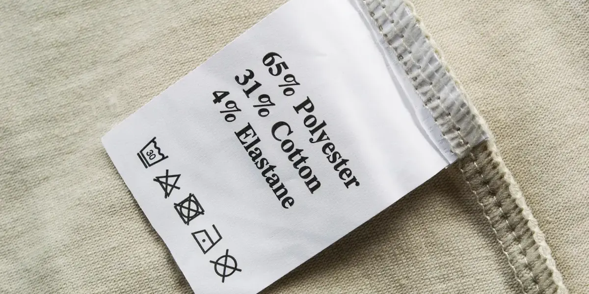 Close-up of price tags displaying varied discount percentages (20%, 30%, 50%) attached to different clothing items.