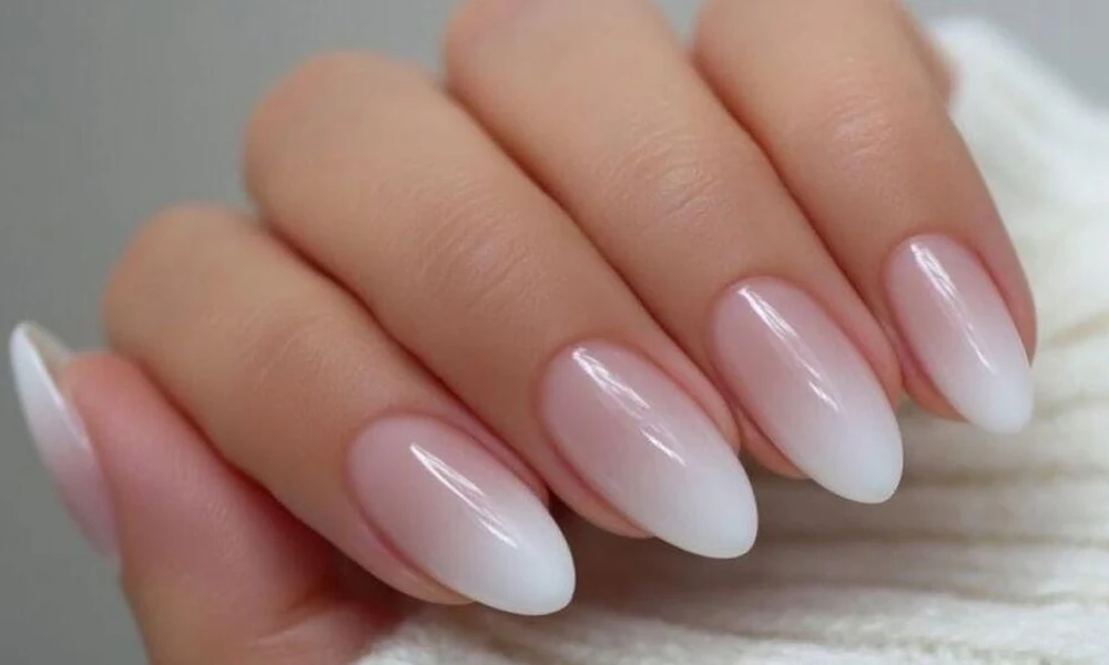 Almond-shaped nails showcasing a seamless pink-to-white French ombre gradient transition