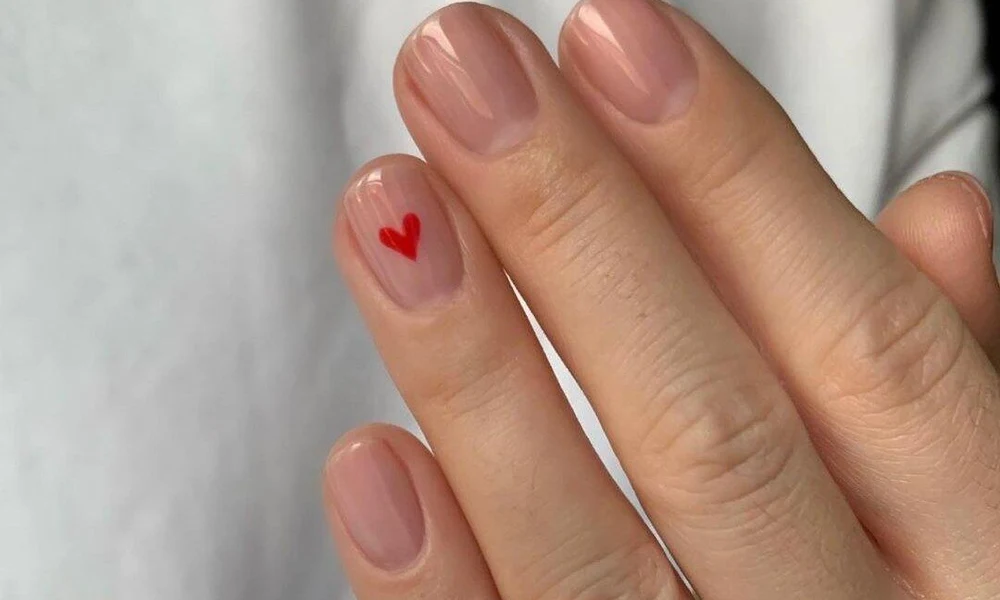 A girl hand with Heart Gel Nails is visible and giving vey elegant look.