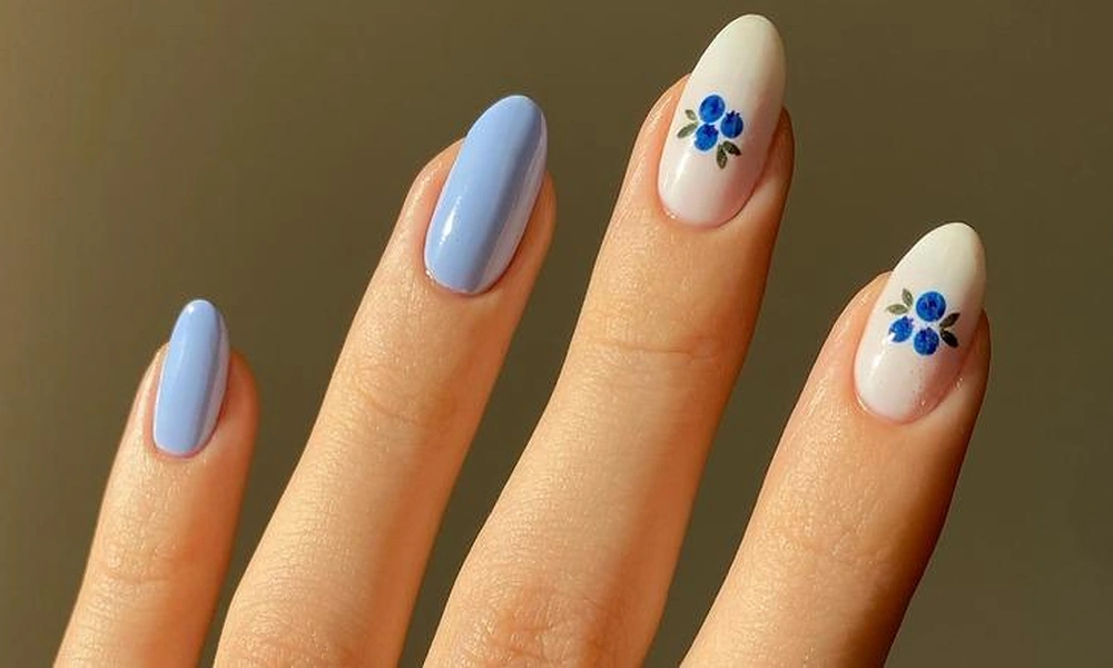 Pastel blue polish paired with milky white accent tips featuring tiny painted blueberry clusters-Cute Nail Ideas