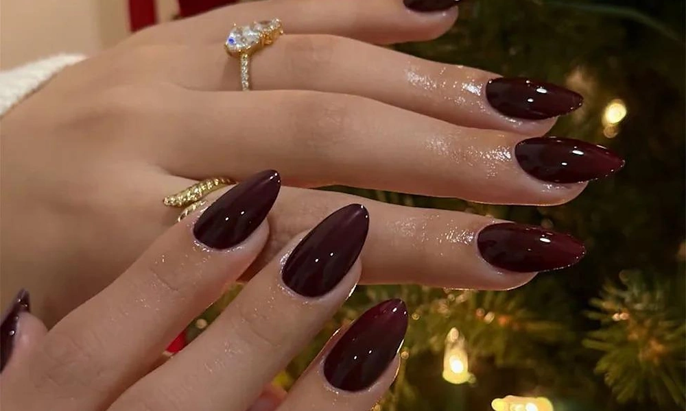 Rich and sophisticated burgundy Christmas nails with a high-gloss finish