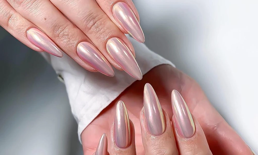 Reflective pink pearl chrome gel x nails with a dramatic stiletto finish