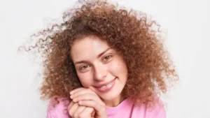 a girl with brown curly hairs