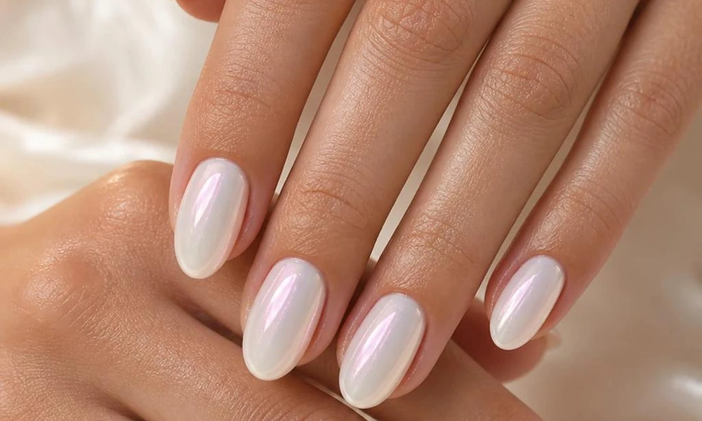 Almond-shaped milky white gel polish with a shimmering pearlescent chrome sheen