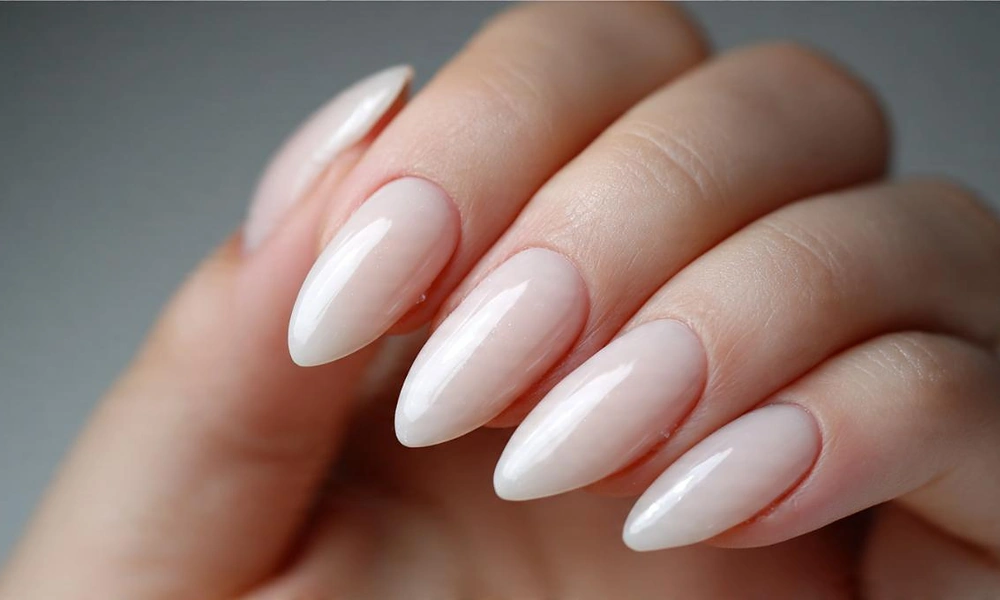 Soft semi-sheer off-white gel polish offering a clean minimal finish on almond tips