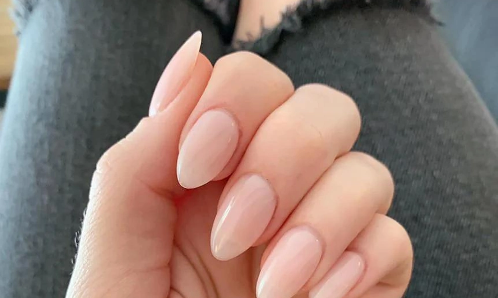 Classic short natural nude gel x nails with a glossy finish for an elegant everyday look