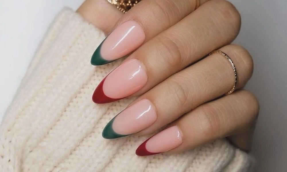 Chic almond-shaped Christmas French tip nails alternating between deep red and forest green edges