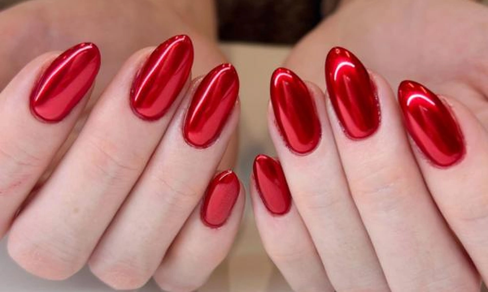 Bold and vibrant red chrome Christmas nails with a high-shine reflective finish