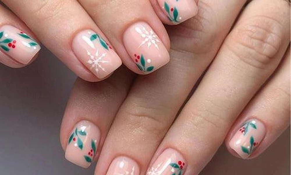 Short Christmas nails decorated with hand-painted green holly leaves, red berries, and delicate white snowflakes