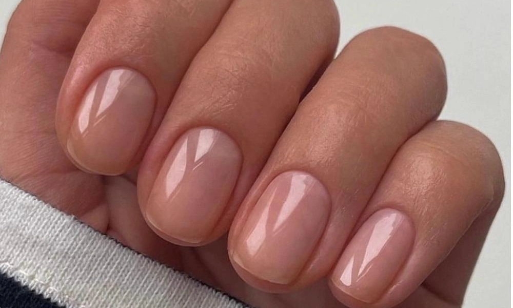 Clean short square natural nails finished with a glossy translucent nude gel coating