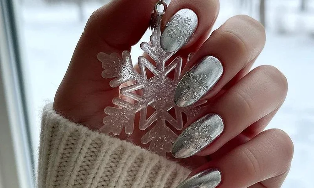 Icy silver chrome Christmas nails patterned with intricate frosted snowflake designs