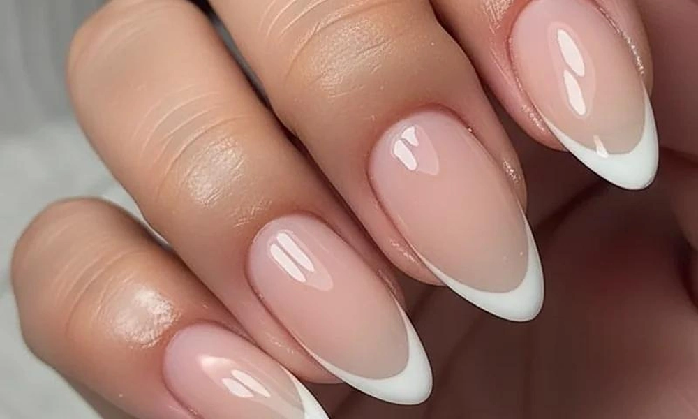 Clean white gel x french tip nails on almond shaped extensions for a timeless manicure